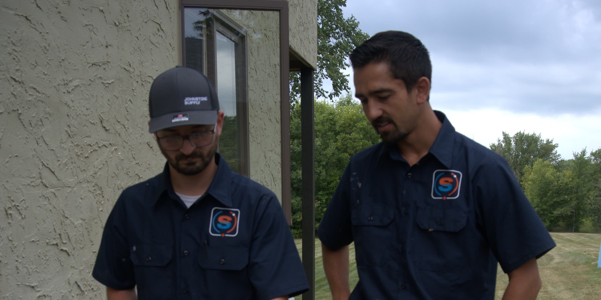 Justin Fodor and John of Temperstead Heating & Air at a customer's condenser