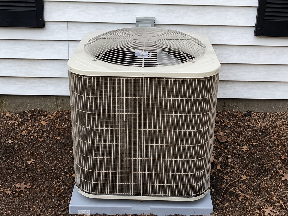 Worn, weathered AC condenser before replacement