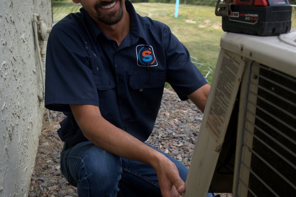 Justin performing a Super Clean tune-up at a Twin Cities home